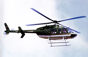 A Performer is flying in a Helicopter Bell 407 and looking at the exhibition from above for 2-3 minutes and then flying away.